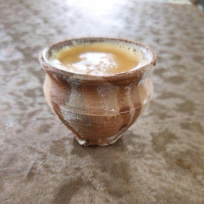 Masala chai poured into a clay kulhad