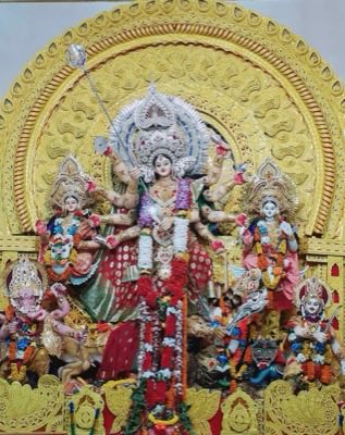 Durga idol with many arms flanked by her children, lion visible at the base
