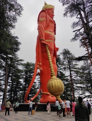 Giant orange Hanuman statue holding a mace