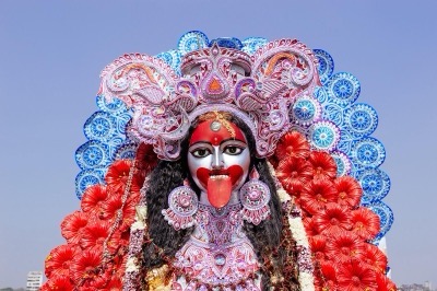 Close-up of a black-faced Kali idol with tongue out